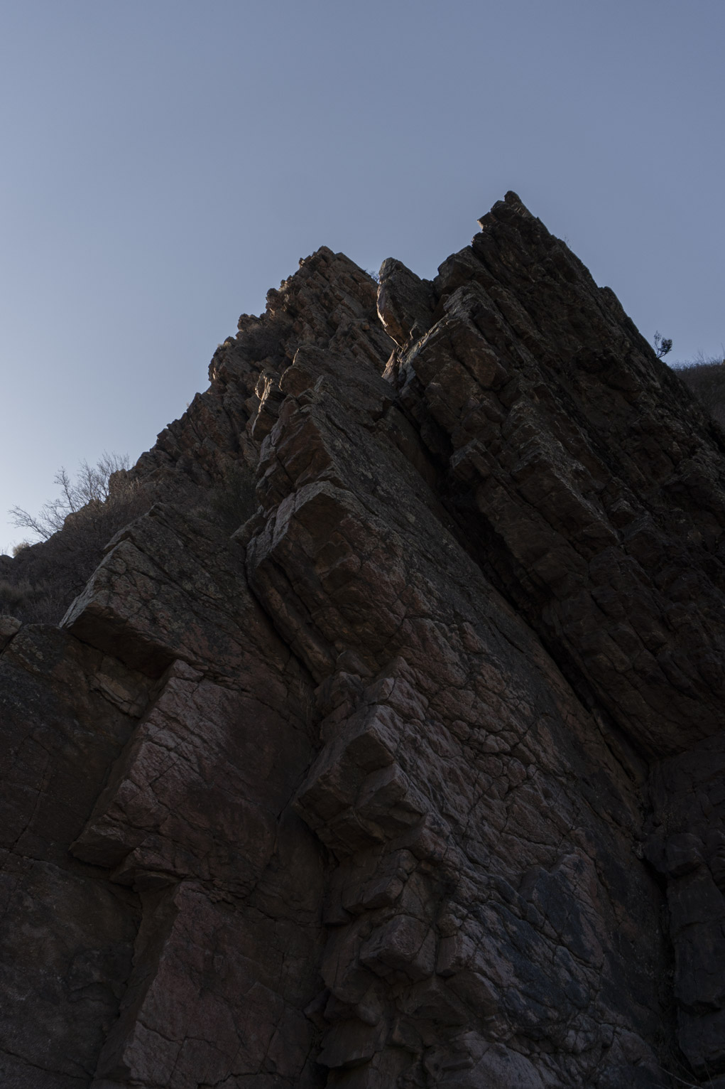 The rocky ridge soars up into the sky, you can see its cracks and lichens